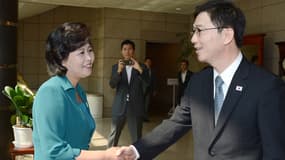 La déléguée de Corée du Nord, à gauche, salue cordialement son homologue du sud, juste avant le début de la réunion Nord-Sud.