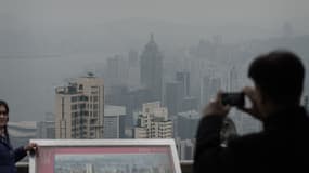 Des touristes immortalisent le nuage de pollution permanent qui flotte au-dessus de Hong Kong.