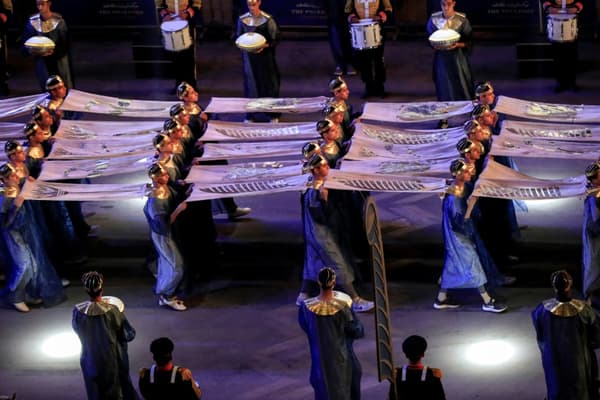 Extras dressed in pharaonic clothing parade on April 3, 2021 in Cairo, accompanied by the march of rafts carrying 22 royal mummies between the Cairo Museum and the National Museum of Egyptian Civilization