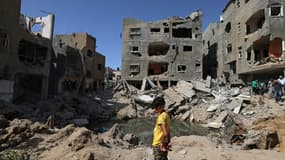 Un enfant palestinien devant des immeubles détruits par des frappes israéliennes, le 21 mai 2021 dans la bande de Gaza