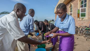 Paroissiens se lavant les mains pour lutter contre le Covid-19, le 22 mars 2020 à Lilongwe, au Malawi