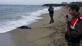 Des soldats trucs prennent en photo le corps d'un migrant retrouvé sur une plage turque mardi.