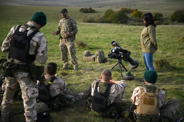 Ukrainian personnel listen to a British instructor during a five-week combat training course with the British Armed Forces near Durrington, southern England, on October 11, 2022.