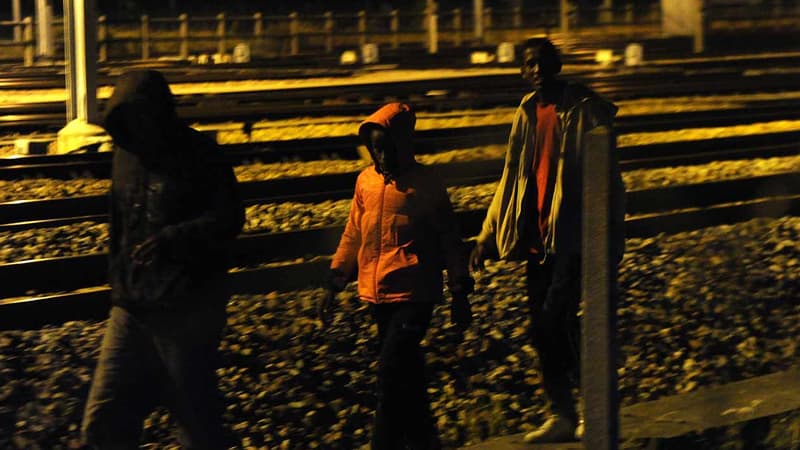 Des migrants marchent le long de rails à Calais, avant de tenter de traverser la Manche pour atteindre la Grande-Bretagne