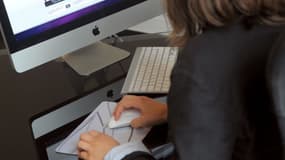 Une femme travaillant sur un ordinateur, image d'illustration.
