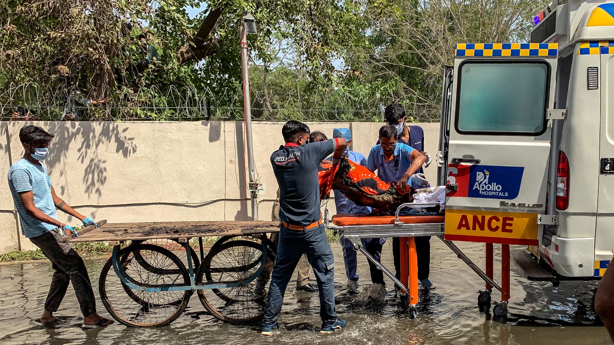 Doctors transfer the bodies of the victims to an ambulance after the Air India flight accident in a residential area near Ahmedabad airport on June 12, 2025. Doctors transfer the bodies of the victims to an ambulance after the Air India flight accident in a residential area near Ahmedabad airport on June 12, 2025.