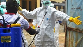 Des membres de la Croix-Rouge se préparent à transporter le corps d'une victime d'Ebola, à Conakry, le 14 septembre 2014.