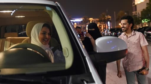 Une Saoudienne filme et apporte son soutien à Samar Al-Moqren (G) au volant de sa voiture à Ryad le 24 juin 2018, jour de la levée de l'interdiction aux femmes de conduire Une Saoudienne filme et apporte son soutien à Samar Al-Moqren (G) au volant de sa voiture à Ryad le 24 juin 2018, jour de la levée de l'interdiction aux femmes de conduire