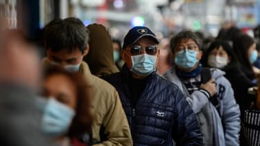 Des ressortissants chinois portant des masques. - Philip FONG / AFP
