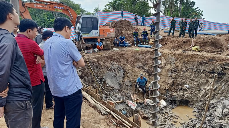 Des sauveteurs sur le site où un garçon de 10 ans est piégé dans un puits de 35 mètres de profondeur dans une zone de construction d'un pont dans la province de Dong Thap au Vietnam, le 2 janvier 2023.