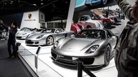 Image d'illustration - Le stand Porsche au Mondial de l'Automobile en octobre, avec de nombreuses voitures grises.
