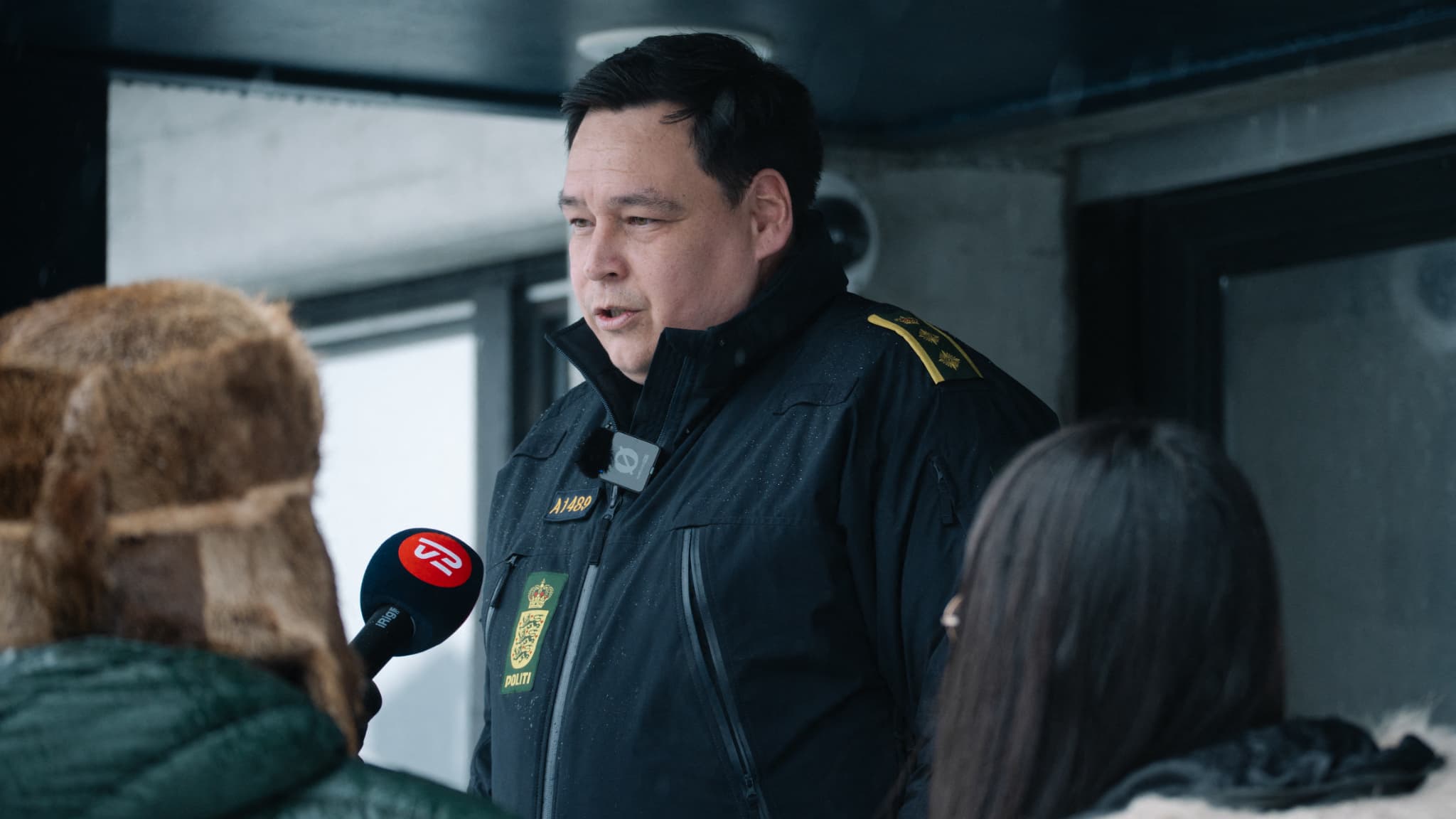 L'inspecteur de police adjoint groenlandais Gideon Kleist (C) s'adresse aux journalistes lors d'une conférence de presse devant le bâtiment des gardes de police à Nuuk, au Groenland, le 24 mars 2025.