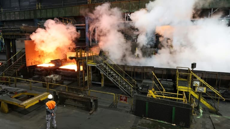 En six ou sept passages sous les rouleaux et les jets d'eau, la barre de métal en fusion de 25 centimètres d'épaisseur s'aplatit et s'allonge en un long et fin ruban d'acier qui servira à fabriquer la torche olympique, dans le laminoir d'ArcelorMittal à Florange, le 4 avril 2024 
