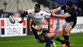 Le centre français Virimi Vakatawa (g) passe le ballon lors du match des Six Nations contre l'Ecosse, au Stade de France, le 26 mars 2021