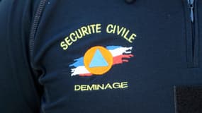 This photo taken on June 9, 2016 in Marly-le-Roi shows the logo of the National Demining Unit of the Ministry of Interior on a member's shirt.
AFP