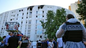 Un membre de la police scientifique devant l'immeuble résidentiel où un incendie a fait sept morts, le 18 juillet 2024 à Nice