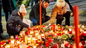 Des personnes en deuil allument des bougies devant un mémorial improvisé près du lieu où un incendie a ravagé un bar pendant les célébrations du Nouvel An dans la station de ski alpine de Crans-Montana, faisant environ 40 morts et plus de 100 blessés, à Crans-Montana, le 2 janvier 2026.