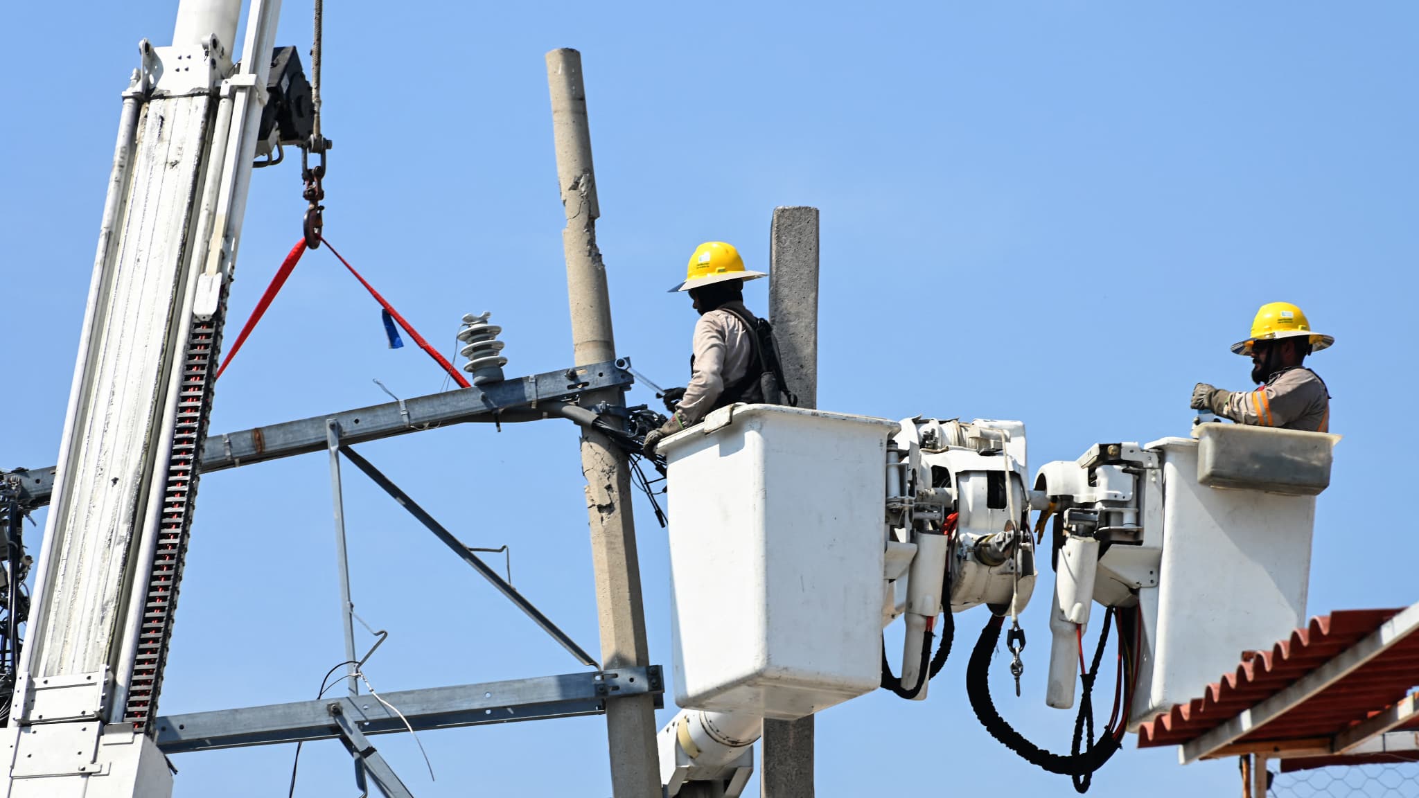 Des travailleurs de la Commission fédérale de l'électricité réparent le réseau électrique après les destructions causées par l'ouragan Otis à Acapulco, dans l'État de Guerrero, au Mexique, le 6 novembre 2023. 