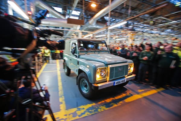 A handout photo taken on January 29, 2016, in Solihull, central England, shows the last-ever Land Rover Defender vehicle to be produced by Jaguar Land Rover, as it is driven off of the production line. The last-ever Land Rover Defender, a vehicle beloved by Queen Elizabeth II and featured in Hollywood blockbusters, rolled off the production line in Britain today. Indian-owned carmaker Jaguar Land Rover had already announced in late 2013 that the group would stop making the legendary Defender at its car plant in Solihull in the West Midlands in central England.