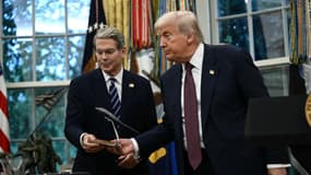 Le président américain Donald Trump remet au secrétaire au Trésor Scott Bessent une maquette d'une nouvelle version du bombardier furtif B-2 alors qu'il s'exprime dans le Bureau ovale de la Maison Blanche à Washington, DC, le 6 août 2025.