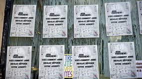 Des affiches collées sur la vitrine d'un magasin par Transparence Citoyenne dénoncent les notes de frais de représentation d'Anne Hidalgo, le 2 octobre 2025, à Paris.