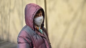 Une femme avec un masque protecteur devant l'hôpital de Huashan à Shanghai, le 21 janvier 2020 en Chine