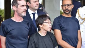 Les deux ex-otages français entourent l'ex-otage sud-coréenne lors de leur réception au palais présidentielle du Burkina Faso