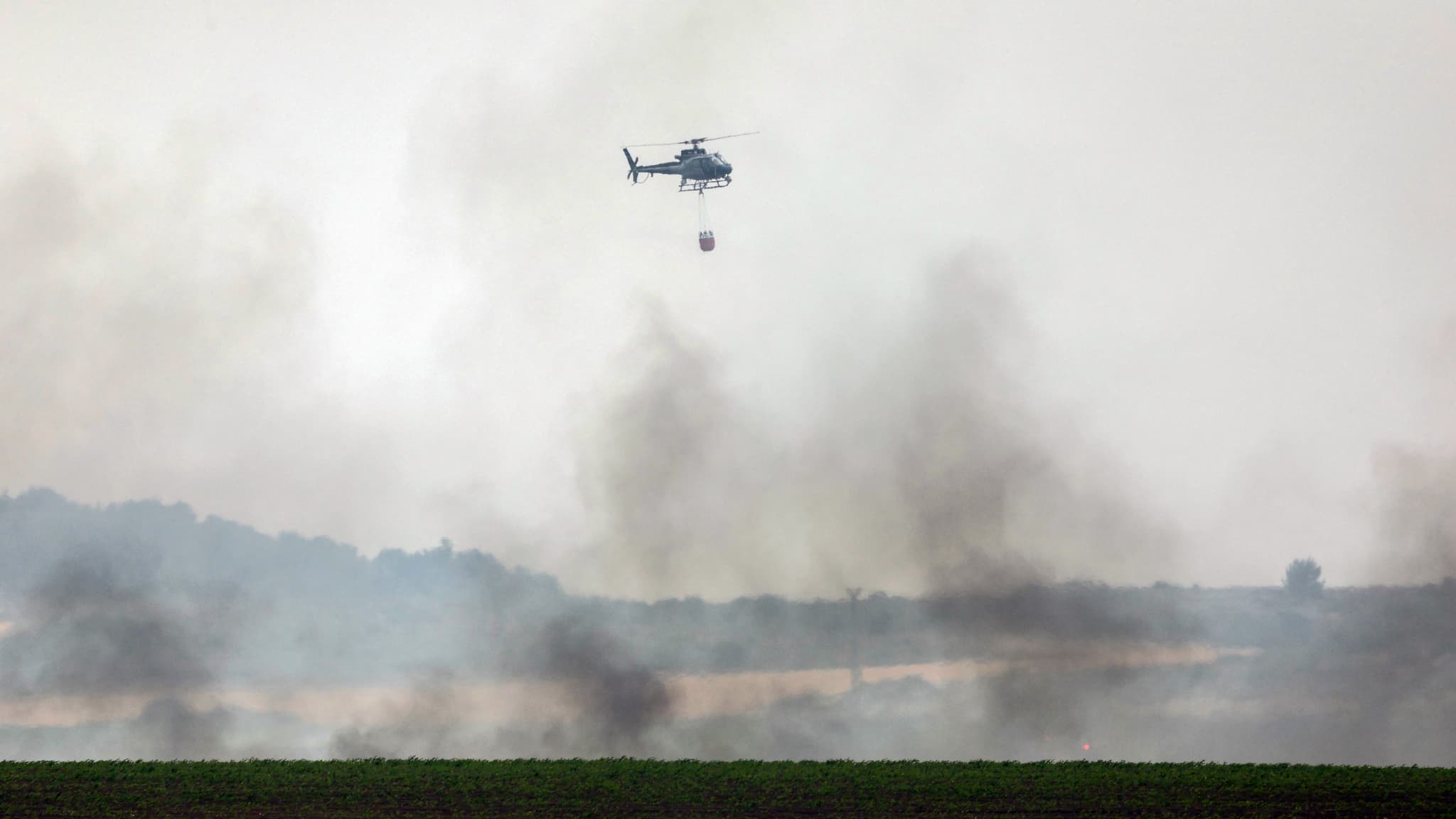 A helicopter is preparing to release water on a fire that began a few kilometers from Jerusalem on April 30, 2025.