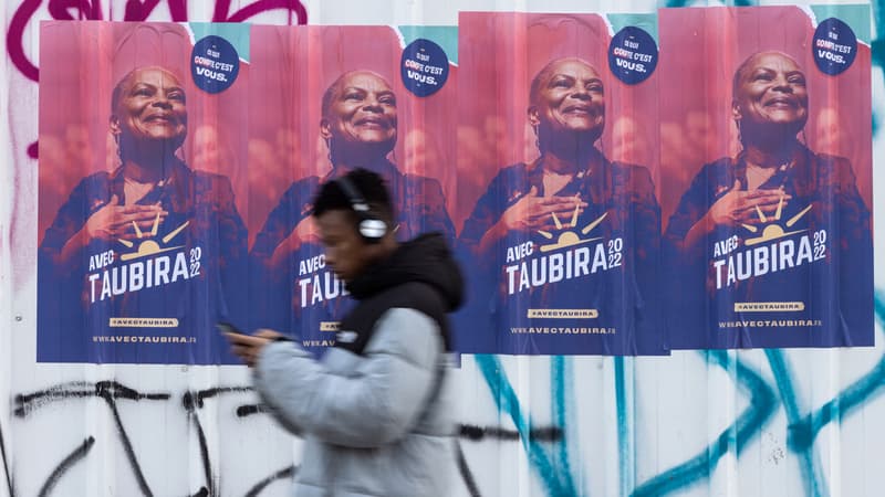 Un passant devant une affiche de Christiane Taubira en janvier 2022 à Paris