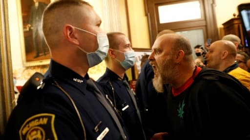 Un manifestant anti-confinement crie sur des policiers au siège du Parlement du Michigan, à Lansing, le 30 avril 2020