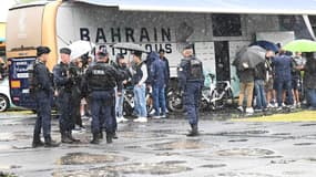 Des CRS à proximité d'une caravane de l'équipe Bahrain Victorious sur le Tour de France, juillet 2025