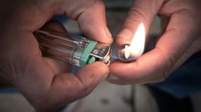 Un fumeur de crack allume sa pipe artisanale place Stalingrad à Paris, le 2 décembre 2020.