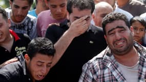 Des Palestiniens pleurent la perte de proches dont des enfants, le 19 juillet à Gaza.