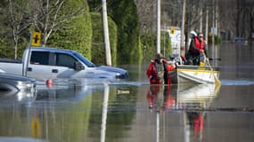 Des policiers canadiens dans une rue inondée de la banlieue de Montréal