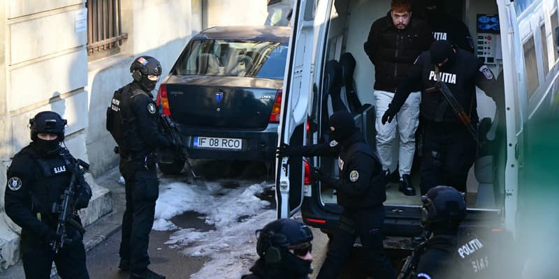 Des policiers roumains escortent Mohammed Amra pour le conduire à la cour d'appel de Bucarest le 23 février 2025.
