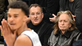 Michael Douglas (R) watches Metropolitan 92's French power forward Victor Wembanyama
