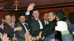 Le président syrien Bachar al Assad (au centre) à l'issue de son discours à Damas. Les combats se sont poursuivis lundi dans la capitale syrienne et dans plusieurs régions du pays au lendemain du discours du chef de l'Etat, mal reçu partout, sauf en Iran.