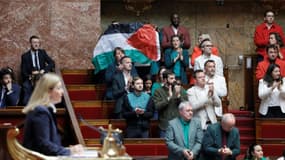 La députée LFI Rachel Keke brandit un drapeau palestinien dans l'hémicycle de l'Assemblée nationale le 4 juin 2024 à Paris.