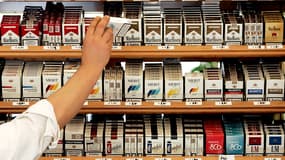 Un buraliste en train de prendre un paquet de cigarettes pour le vendre (Photo d'illustration) -AFP