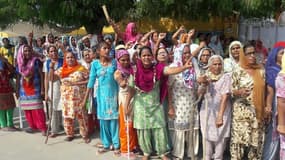 Followers of Gurmeet Ram Rahim Singh, the controversial head of religious sect Dera Sacha Sauda (DSS), gather on the roadside in Sirsa, where his organization is based, ahead of a court's verdict in a rape case against him