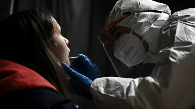 Un personnel de santé pratique un test pour détecter le Covid-19 sur une élève au sein du complexe scolaire Fénelon Notre-Dame à La Rochelle, le 13 janvier 2022