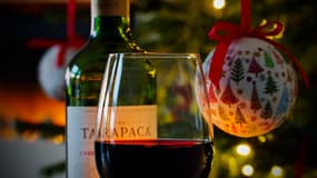 Un verre de vin devant des décorations de Noël.