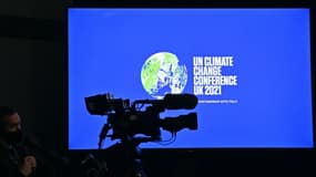 Une caméra de télévision devant le logo de la COP26 sur un écran, le 9 novembre 2021 à Glasgow, en Ecosse