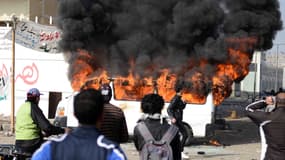 Un minibus incendié par des manifestants, à Port-Saïd, samedi 26 janvier.