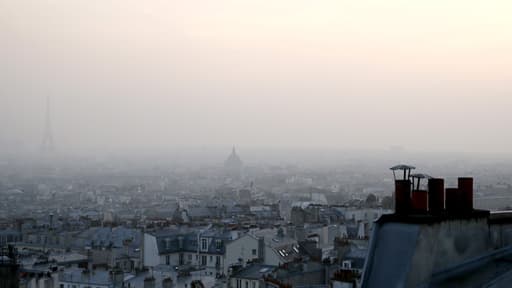 Au pied de la tour Eiffel, la population baigne dans une brume de pollution.