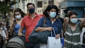 Des passants portant des masques en raison de la pandémie de coronavirus, dans les rues de Bordeaux, en France. 