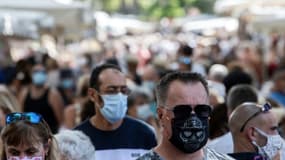 Des personnes portent un masque de protection dans une rue commerçante de Lorgues, le 19 août 2020 dans le Var