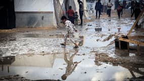 Un enfant palestinien marche en évitant les flaques dans un camp de Palestiniens fuyant les combats, à Rafah, dans la bande de Gaza, le 2 janvier 2024. (Photo d'archive)