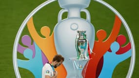 Le capitaine anglais Harry Kane baisse la tête en passant devant le trophée de l'Euro après la défaite en finale contre l'Italie le 11 juillet 2021 à Wembley