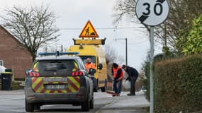 Des agents nettoient la chaussée le 12 février 2024 à Steenbecque, dans le Nord, après un accident qui fait trois morts